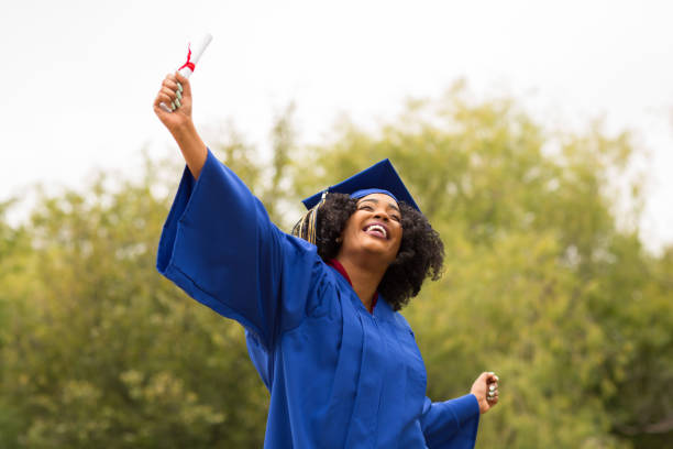 istock Excited young woman on graduation day. 1128583319