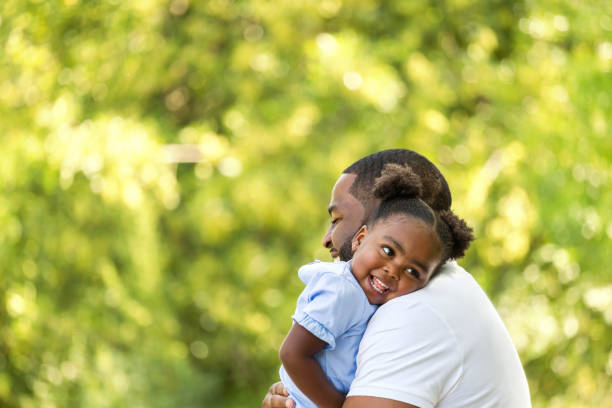 African American father hugging her daughter.