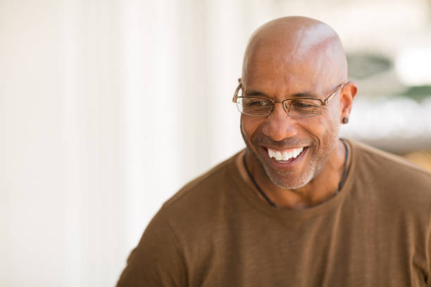 istock Mature African American man smiling wearing glasses. 1128583531