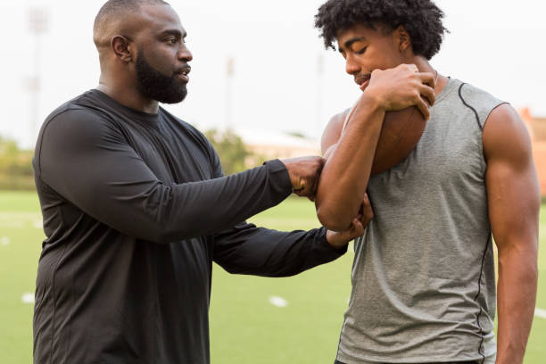 istock American Football coach training a young athlete. 1128583802