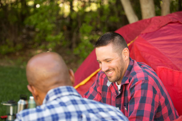 istock Multi-Ethnic group of friends talking and camping 1128584599