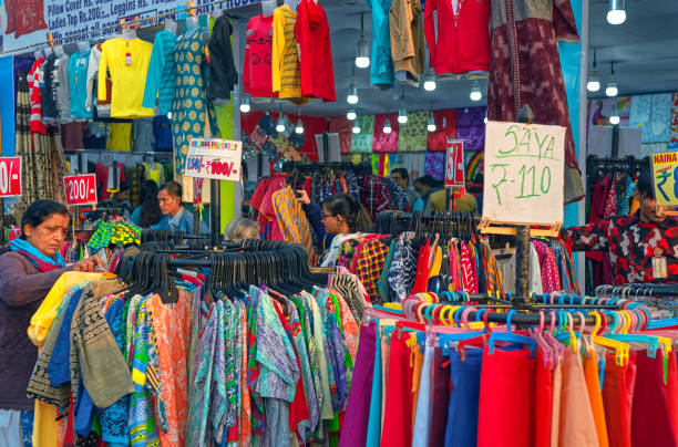 customers selects garments inside a shop at a fairground in kolkata - kurta imagens e fotografias de stock