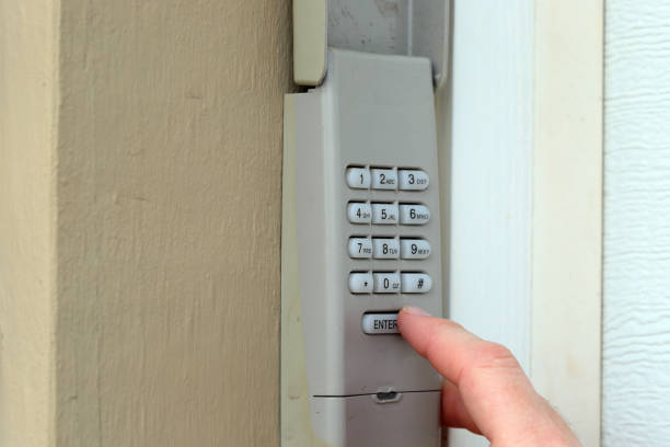 istock hand and finger entering access code pin on keypad - garage door opener - home security 1128590179