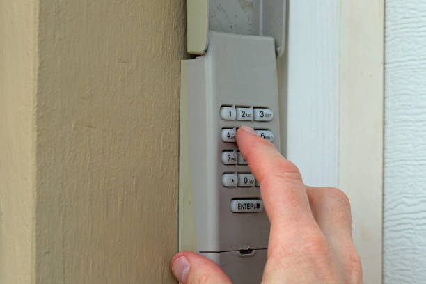 istock hand and finger entering access code pin on keypad - garage door opener - home security 1128590286
