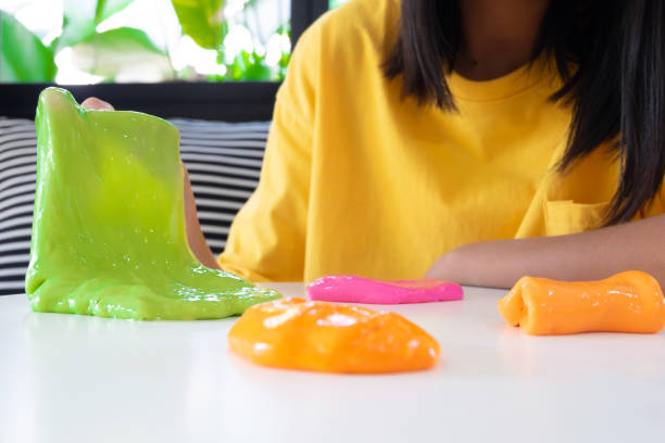 istock Hand Holding Homemade Toy Called Slime, Kids having fun and being creative by science experiment. 1128598054