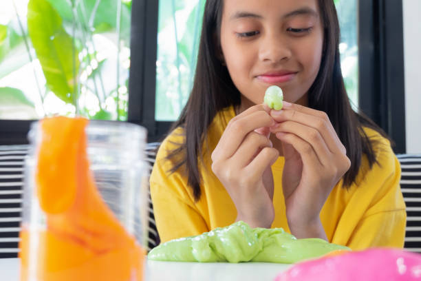 istock Hand Holding Homemade Toy Called Slime, Kids having fun and being creative by science experiment. 1128598111