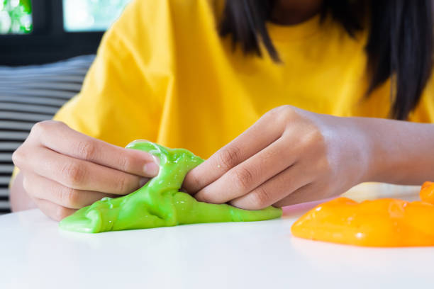 istock Hand Holding Homemade Toy Called Slime, Kids having fun and being creative by science experiment. 1128598143