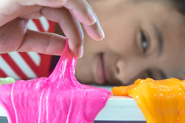 istock Hand Holding Homemade Toy Called Slime, Kids having fun and being creative by science experiment. 1128598237