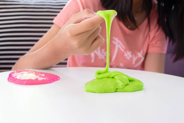 istock Hand Holding Homemade Toy Called Slime, Kids having fun and being creative by science experiment. 1128600062