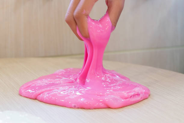istock Hand Holding Homemade Toy Called Slime, Kids having fun and being creative by science experiment. 1128600121