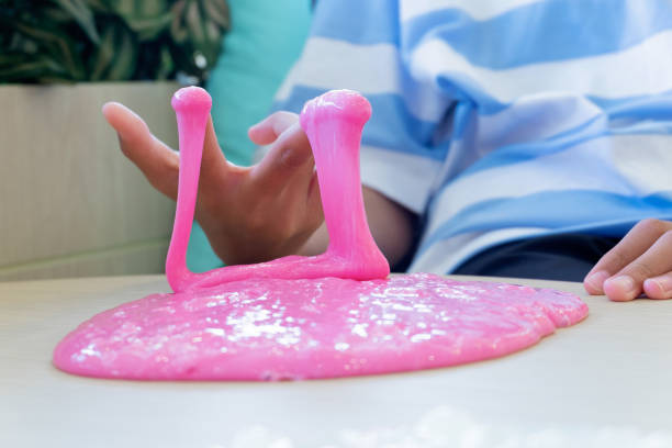 istock Hand Holding Homemade Toy Called Slime, Kids having fun and being creative by science experiment. 1128600161