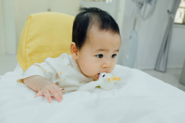 istock Asian baby is chewing on teething toy. 1128600271