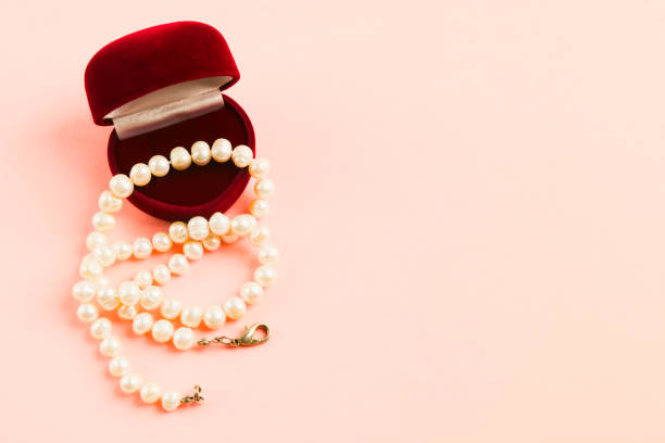 necklace on heads of red roses