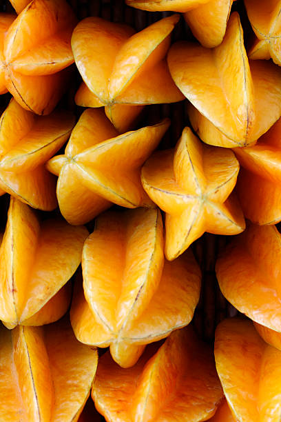 Photograph of multiple starfruit Fresh starfruit at a farmers market. starfruit stock pictures, royalty-free photos & images