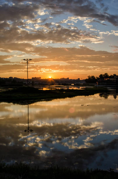 istock Beautiful sunset and the clouds with river in city 1128604815