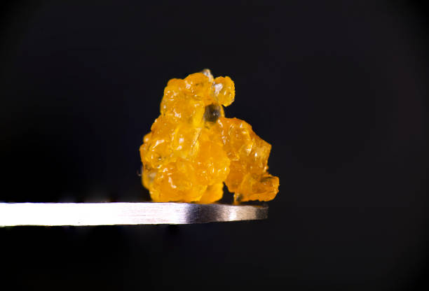 Macro detail of cannabis concentrate HTFSE extracted from medical marijuana Macro detail of cannabis concentrate HTFSE extracted from medical marijuana isolated over black on a dabbing tool dab dance photos stock pictures, royalty-free photos & images