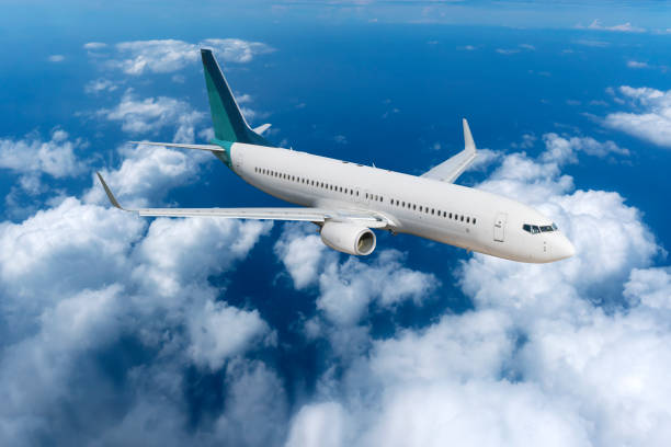 istock Passenger Airliner Airplane flying over the white clouds 1128607696