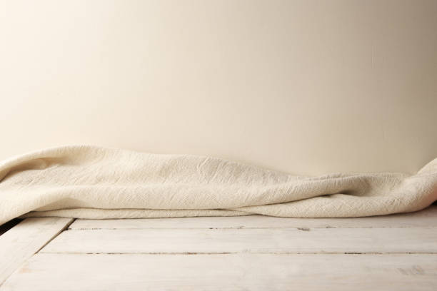 istock Background of white cloth on wooden planking and empty wall. 1128615655