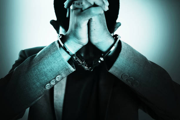 Business Man's hand in handcuff, crime arrested concept