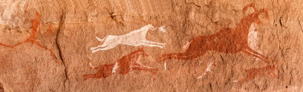 Prehistoric Petroglyphs in libian sahara desert Prehistoric Petroglyphs - Rock Art - Akakus (Acacus) Mountains, Sahara, Libya cave painting photos stock pictures, royalty-free photos & images