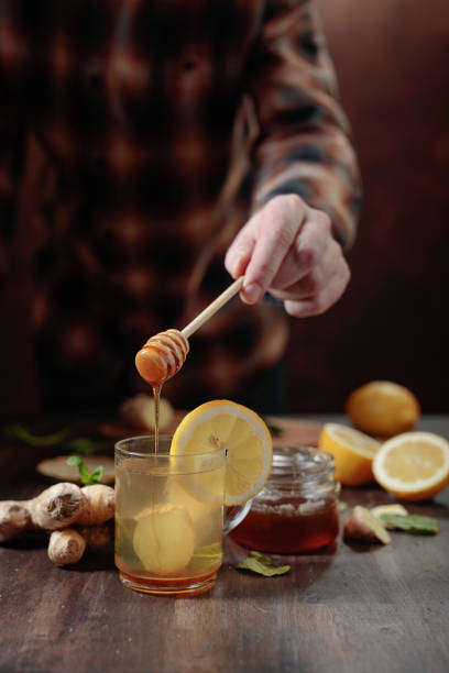istock Ginger tea with honey , lemon and mint on old wooden table . 1128618951