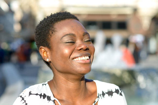 istock Lively young African woman with a beaming smile 1128620098