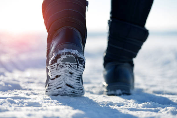 istock Female feet in winter boots. 1128620134