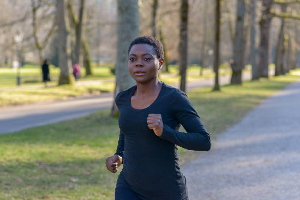 istock Determined young African woman training in a park 1128620215