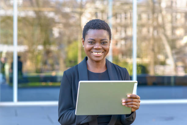 istock Happy young African woman using a tablet 1128621514