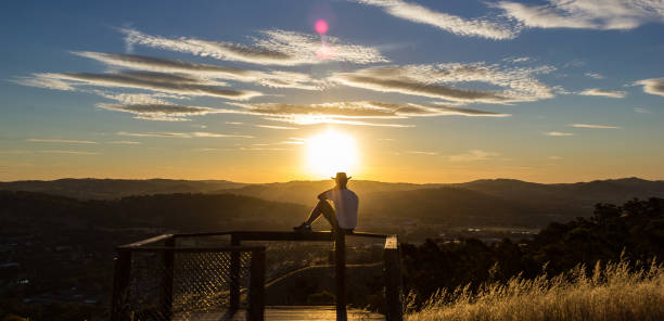 Young man is looking at the sunset, New South Wales, Australia Young man is looking at the sunset, Albury, New South Wales, Australia new south wales photos stock pictures, royalty-free photos & images