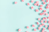 Flowers composition. Pink rose flowers on pastel blue background. Valentines day, mothers day, womens day, spring concept. Flat lay, top view, copy space