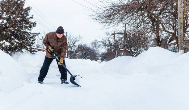istock Man with a shovel cleans the track from the snow 1128622547