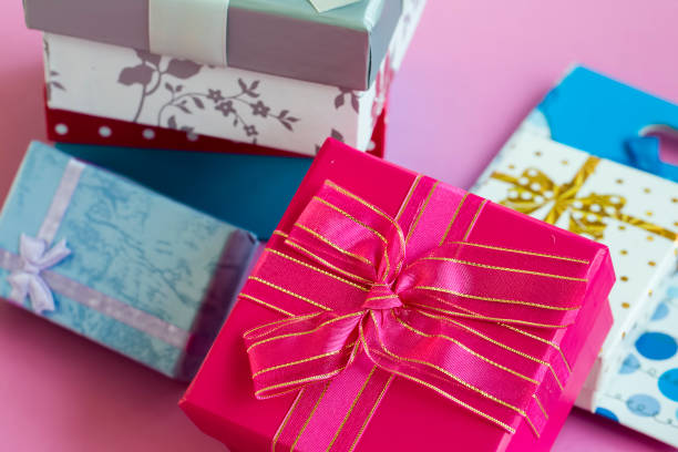 istock Colorful gift surprise packages, on pink background. 1128622959