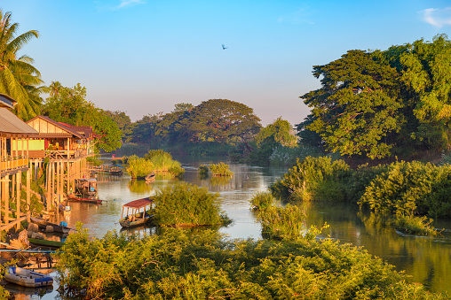 Mekong River 4000 islands Laos, sunrise dramatic sky, mist fog on water, famous travel destination backpacker in South East Asia