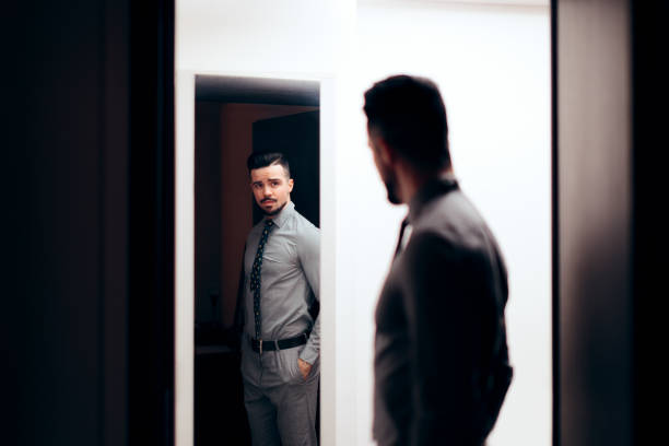 istock Handsome Elegant Man Looking in the Mirror 1128623746