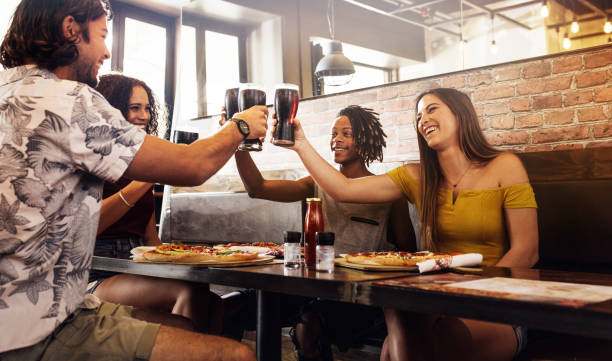 istock Multi-ethnic group of friends toasting soft drinks at cafe 1128624846