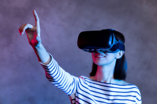 istock Attractive asian girl with VR goggles on head 1128626655