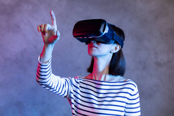 istock Attractive asian girl with VR goggles on head 1128626661