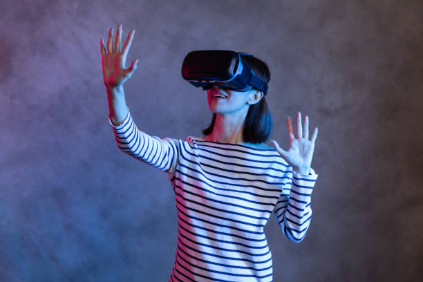 istock Attractive asian girl with VR goggles on head 1128626687