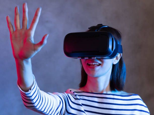 istock Attractive asian girl with VR goggles on head 1128626690