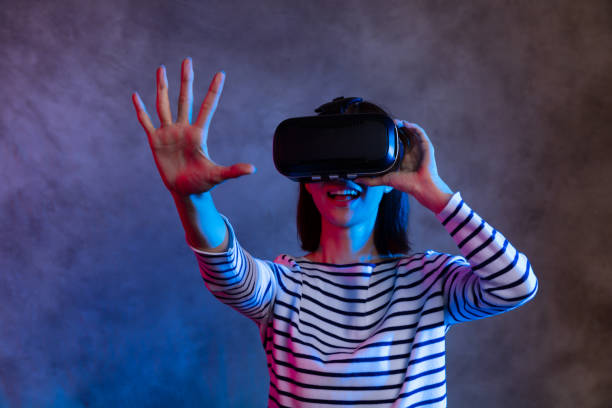 istock Attractive asian girl with VR goggles on head 1128626710