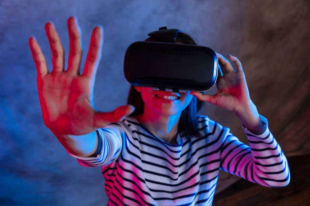 istock Attractive asian girl with VR goggles on head 1128626727