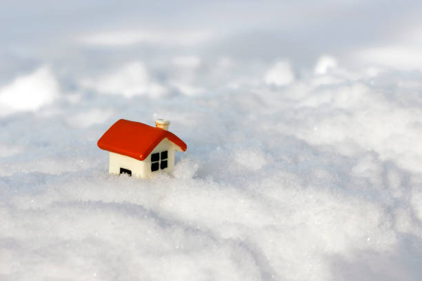 istock toy house stuck in the snow 1128627919