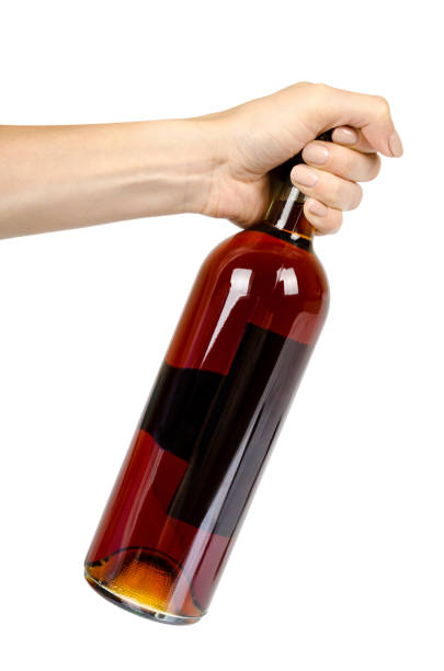 closed bottle of wine with hand, alcohol and addiction concept