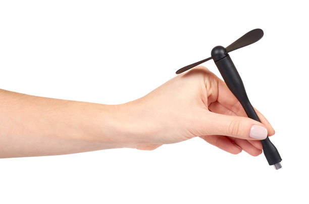 istock Hand with black plastic USB fan for mobile devices or power bank. 1128629376