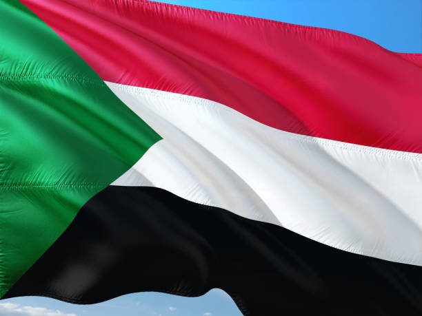 bandeira do sudão balançando ao vento contra o céu azul profundo. tecido de alta qualidade. - republic of the sudan - fotografias e filmes do acervo