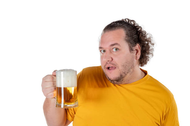istock Funny fat man feeling happy and relaxed, holding fresh cold beer in his hands on white background 1128629814