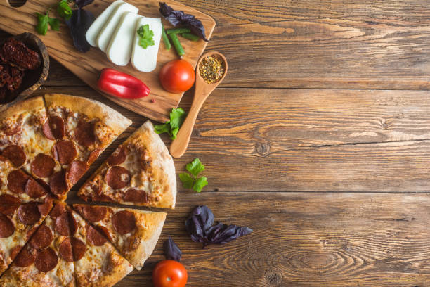 istock Pizza with cheese, pepperoni, chicken and pepper, a slice for a gourmet dinner 1128630608