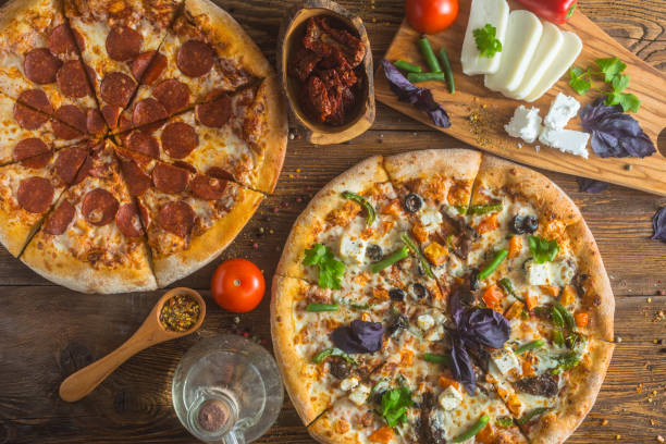 istock Pizza with cheese, pepperoni, chicken and pepper, a slice for a gourmet dinner 1128630717