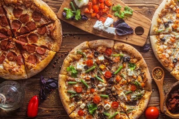 istock Pizza with cheese, pepperoni, chicken and pepper, a slice for a gourmet dinner 1128630742